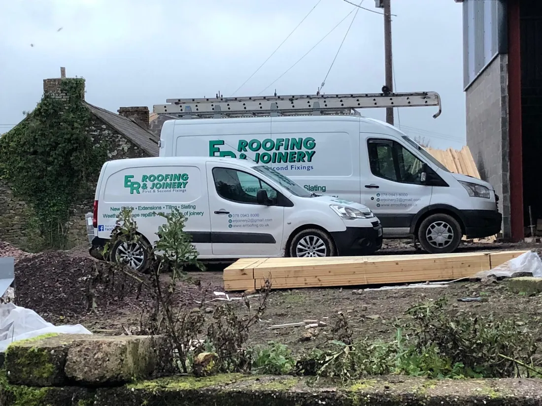 E R Roofing and Joinery vans at work outside a local property