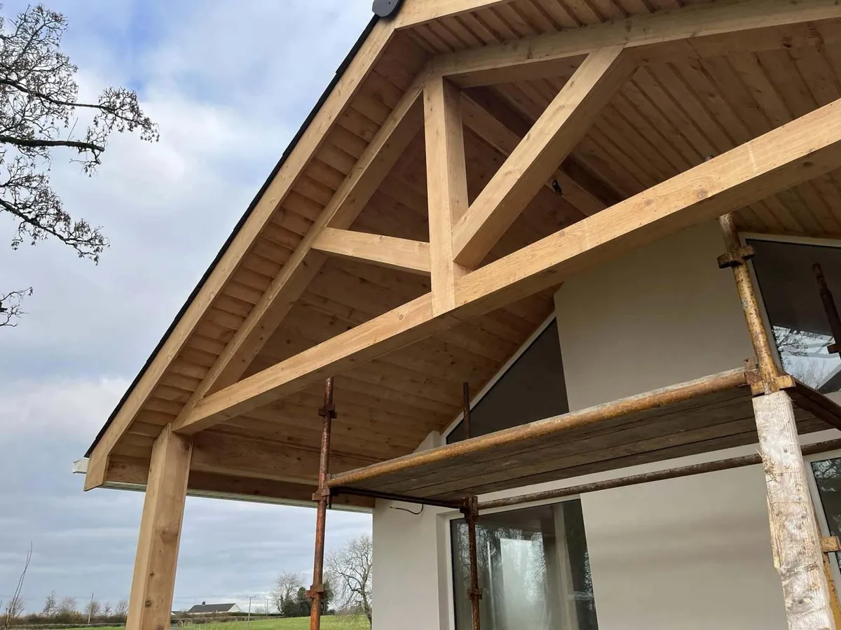 Oak porch canopy built over a stone house entrance