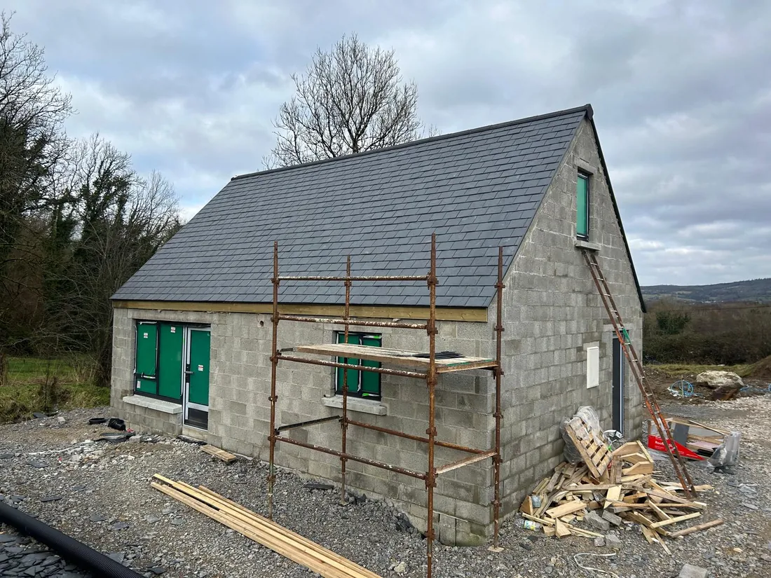 Stone property with scaffolding during roof works