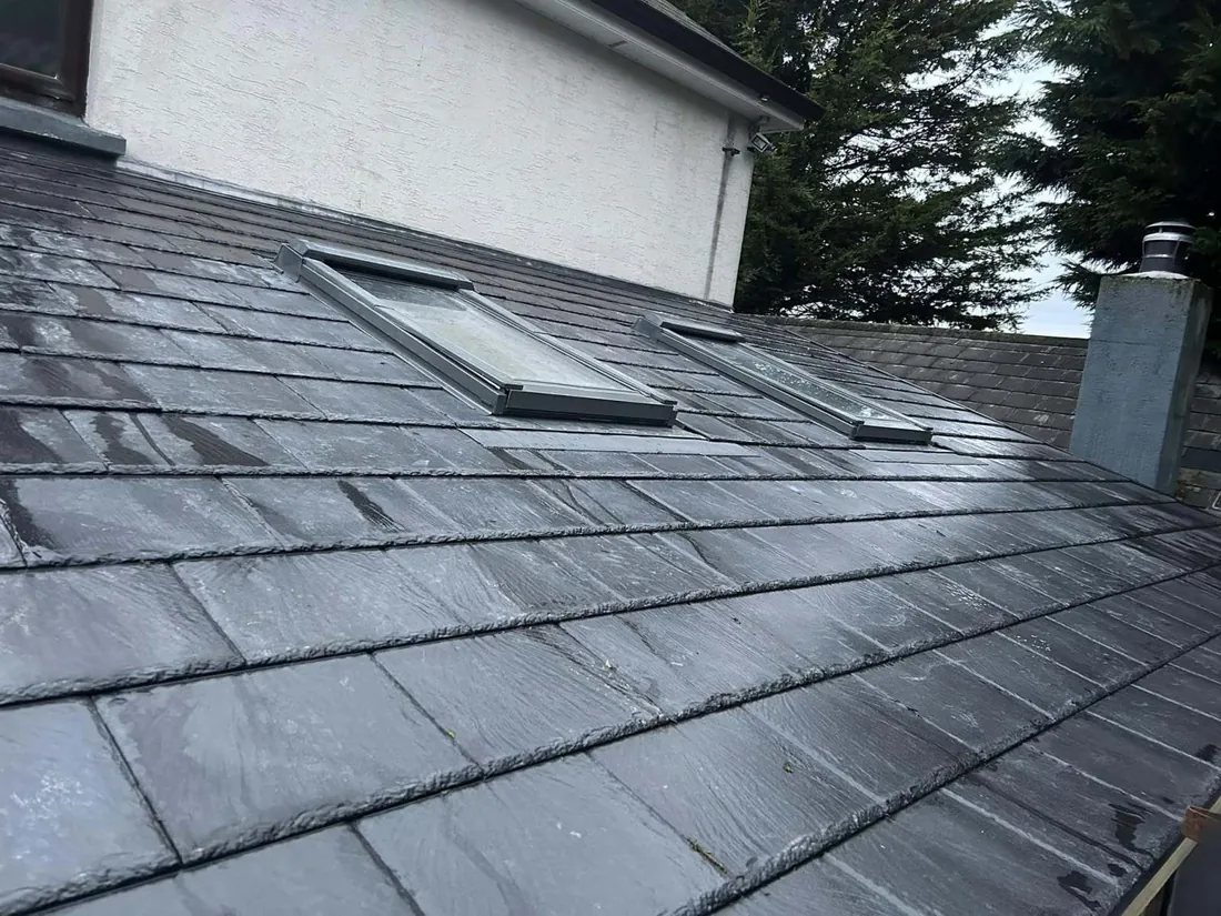 Completed slate roof with a Velux window installed